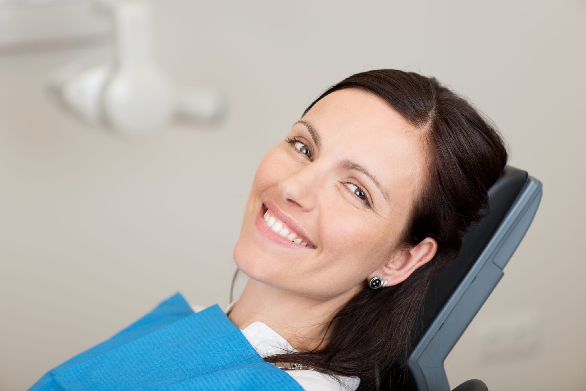 Brunette Female Laying on Dental Chair