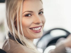 Young Woman Smiling In Car