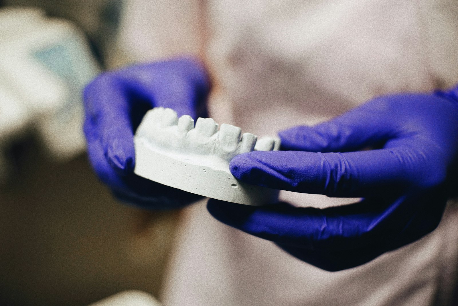 Dentist checking tooth shade while matching a single front-tooth restoration