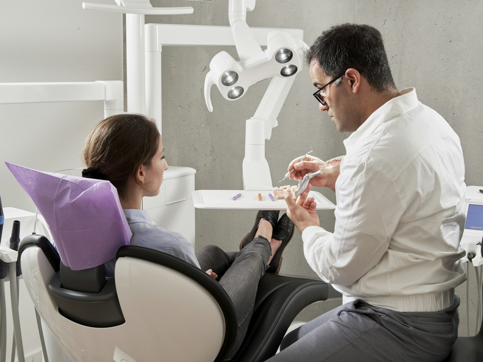 Prosthodontist discussing a second opinion with a patient during a consultation