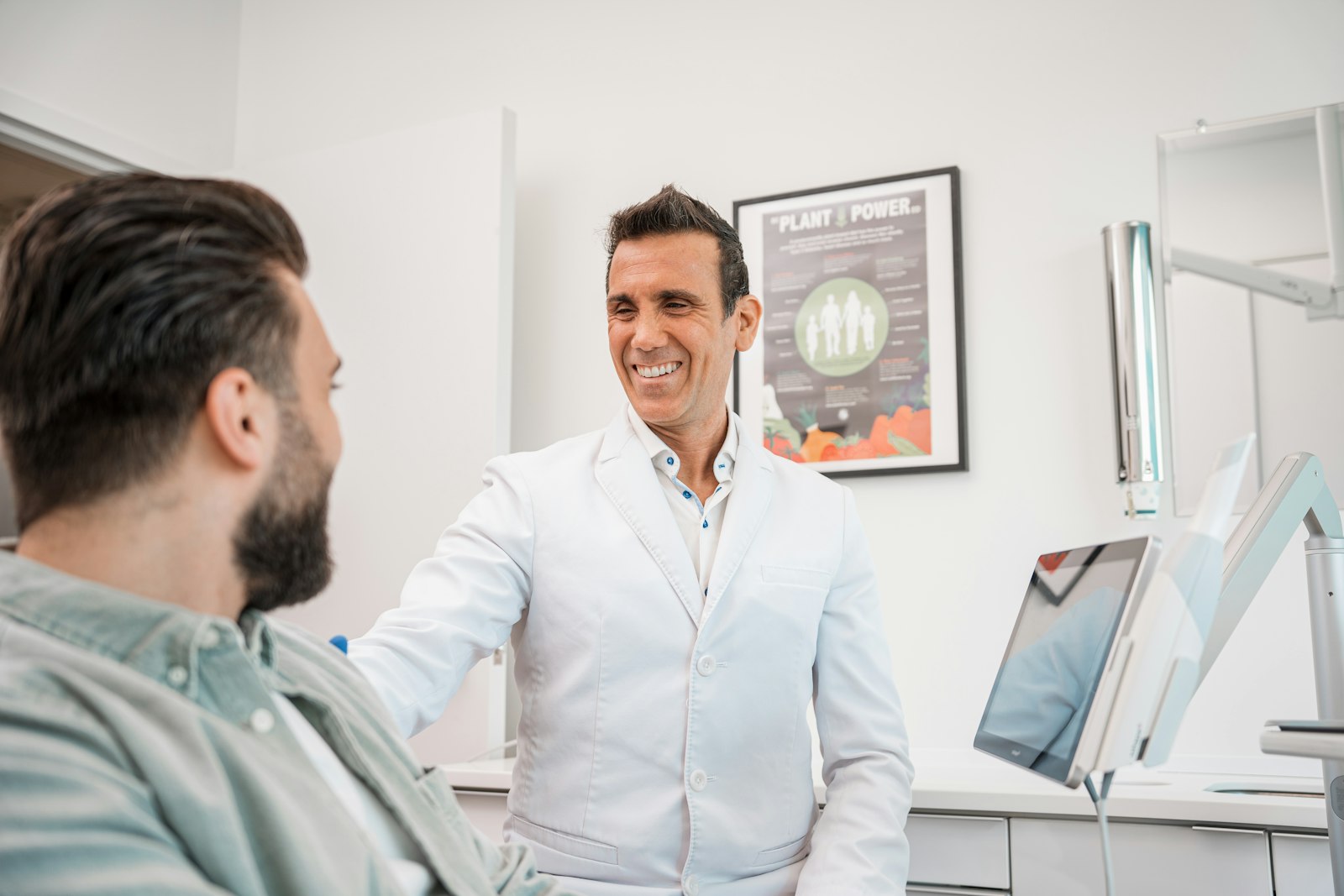 Prosthodontist discussing a front-tooth restoration with a patient