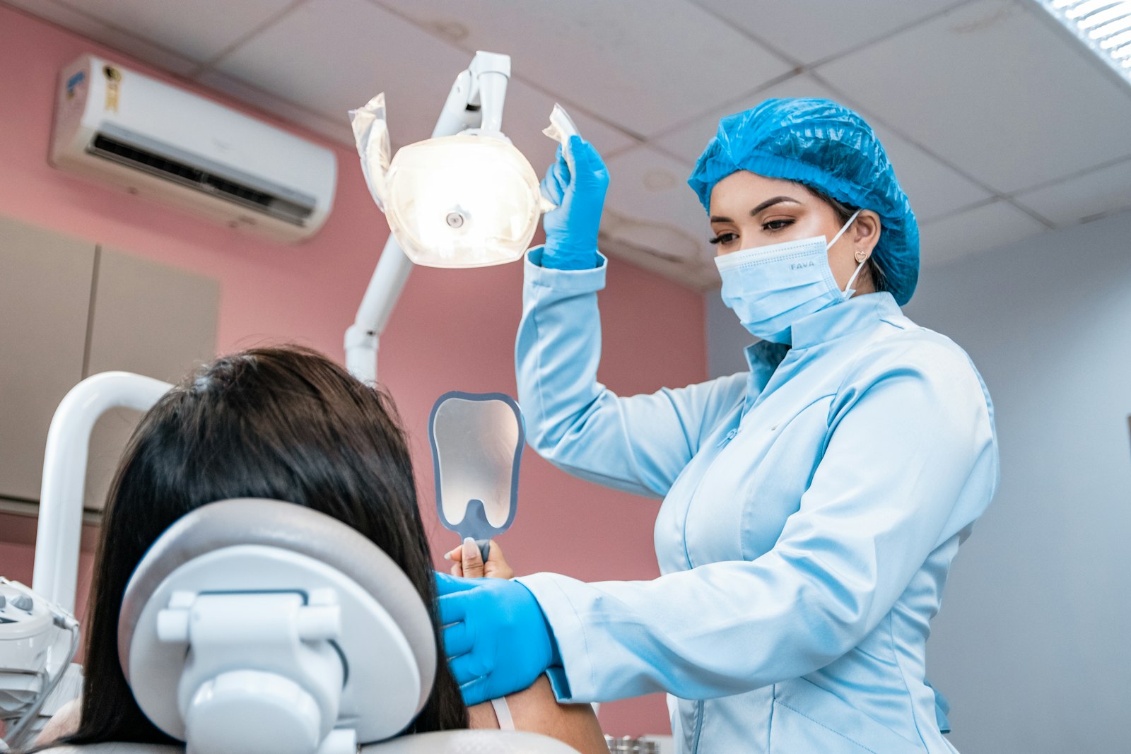 Patient having a restorative dental examination to evaluate crowns and worn teeth