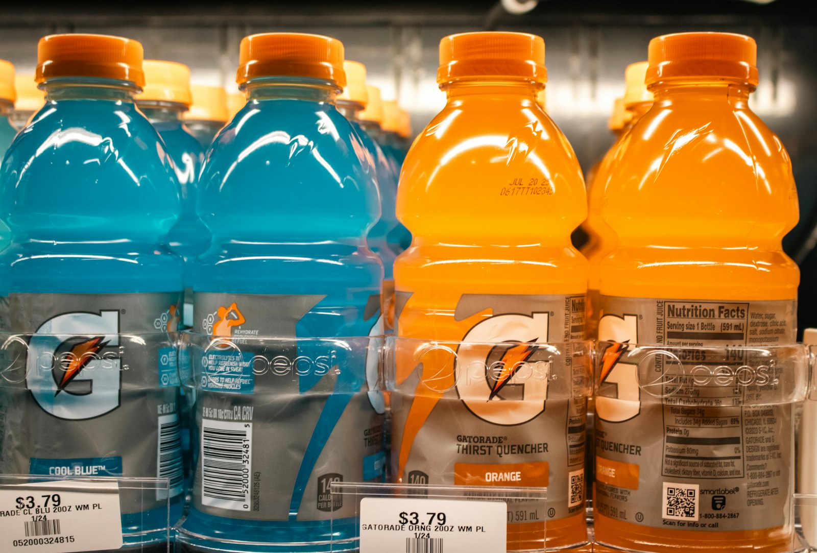 A sports drink bottle, which can be acidic and sugary despite its healthy image