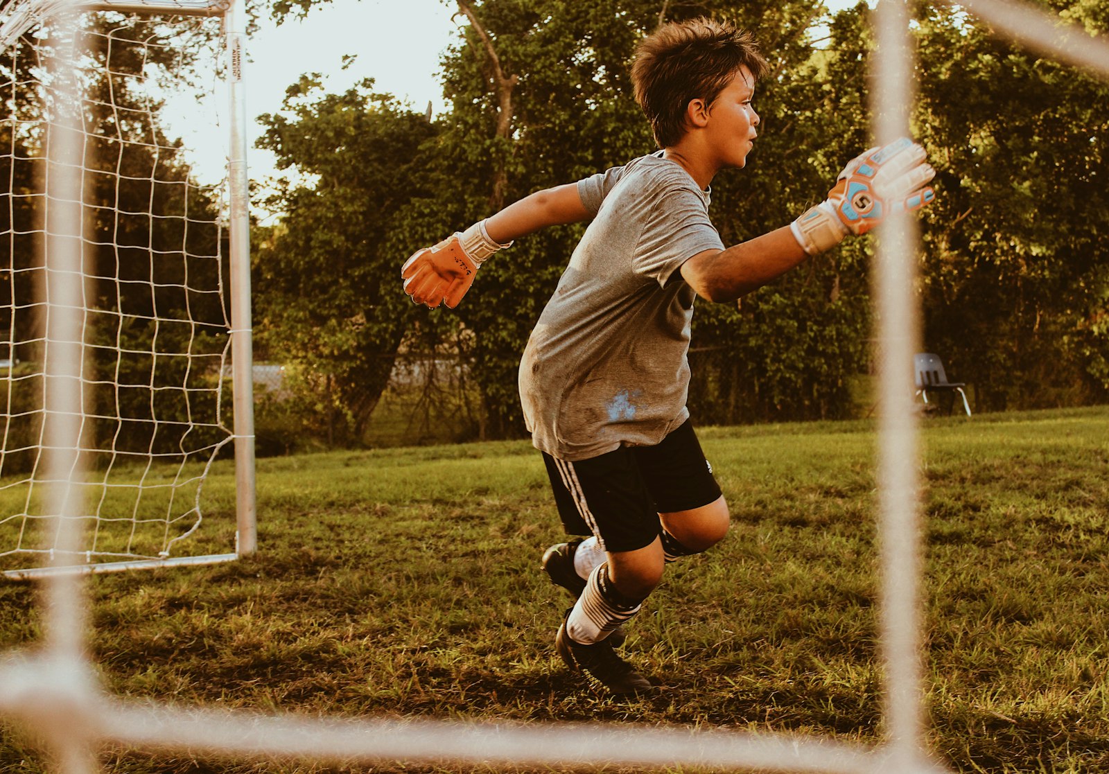 Young soccer player on the field who should wear a properly fitted sports mouthguard