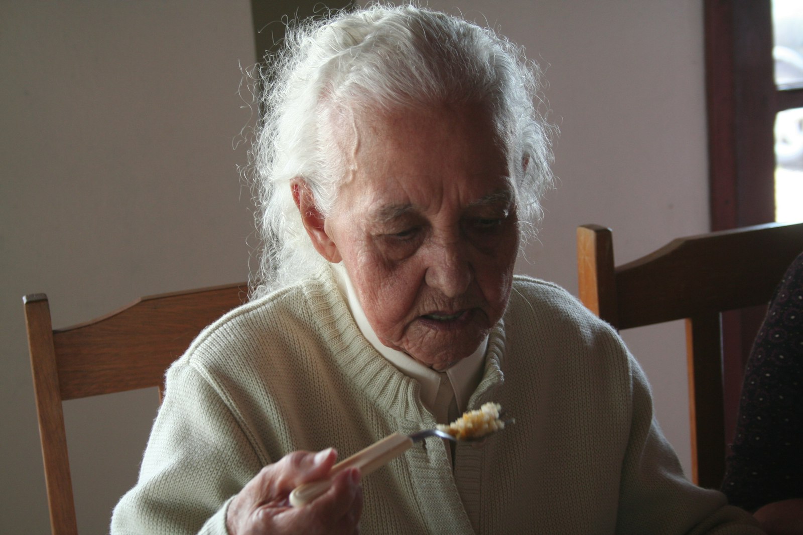 Older adult enjoying a meal comfortably after implant-supported treatment