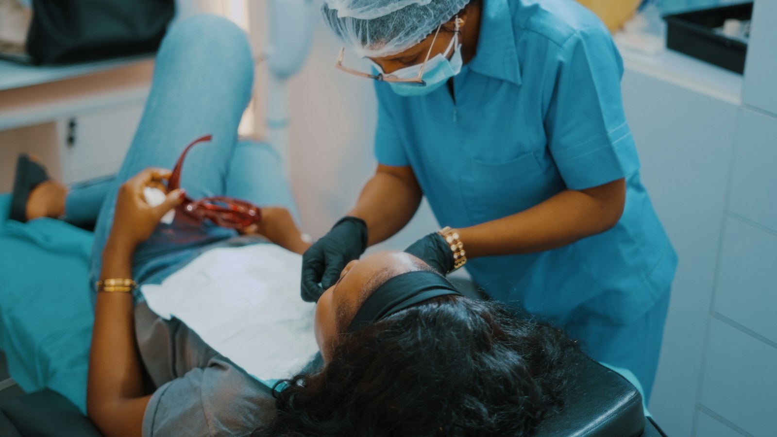 Dentist examining a patient's gums during a checkup in Belmont MA