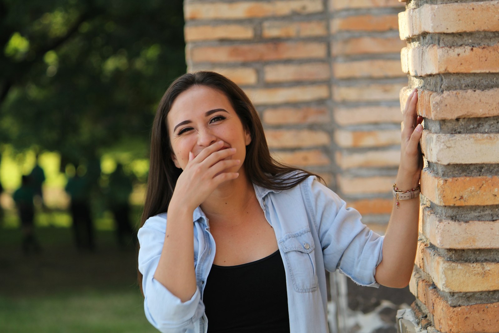 Person self-consciously covering their smile after tooth loss