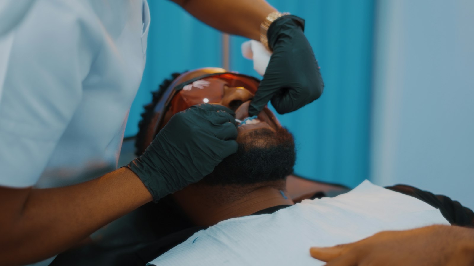 Dentist checking teeth for signs of wear during an exam in Belmont MA
