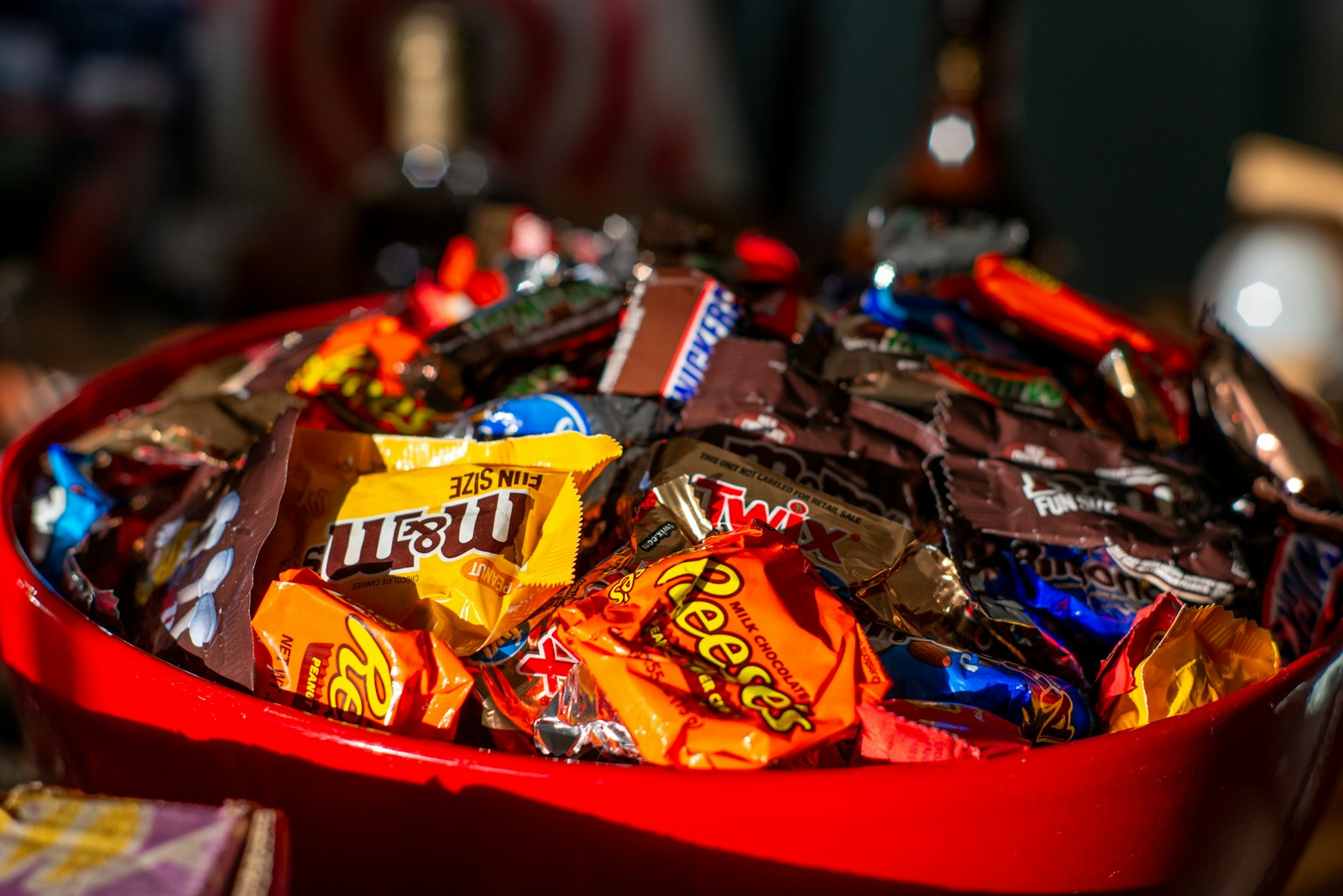 A bowl of assorted Halloween candy and its effect on teeth in Belmont MA