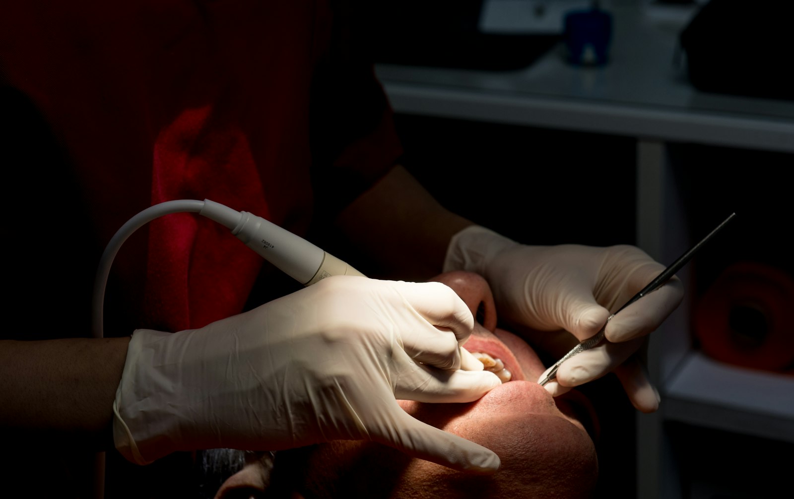 A dentist adjusting a new crown's bite in Belmont MA